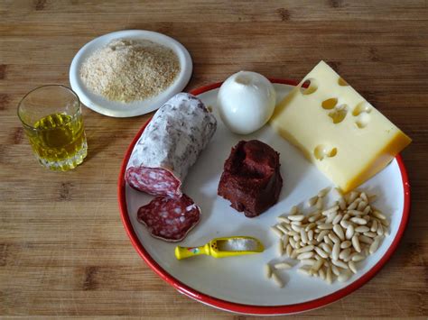 Ingredienti per il ripieno dell'arista: salame, parmigiano, pan grattato, fiori di finocchio