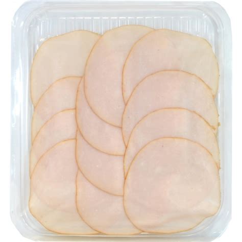 Immagine di un arrosto di tacchino con frutta secca affettato su un piatto da portata