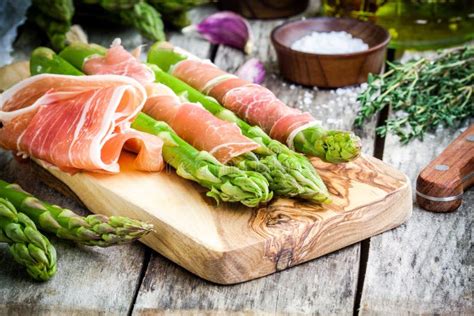 Asparagi freschi disposti su un tagliere di legno