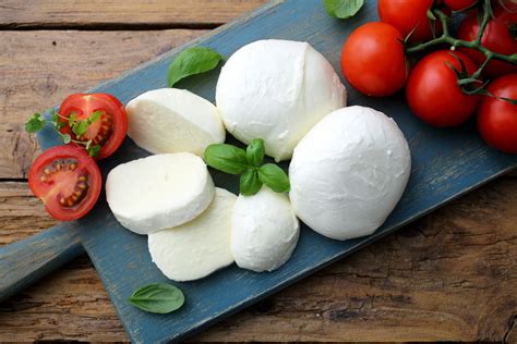 un dettaglio di ingredienti freschi per pizza: pomodoro, basilico, mozzarella