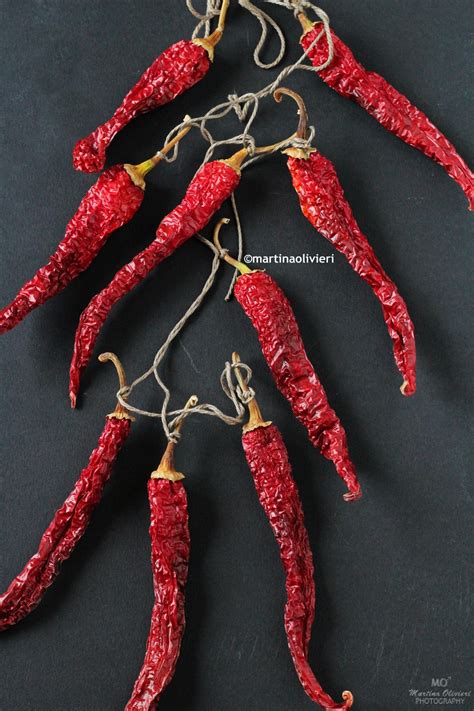 Collane di peperoni secchi appese ad asciugare