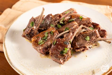 Costolette di agnello che rosolano in padella