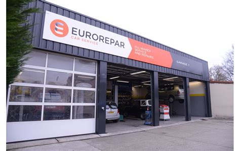 Esterno di un'autocarrozzeria moderna con veicoli in riparazione