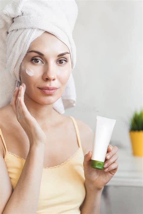 Donna che applica una crema viso