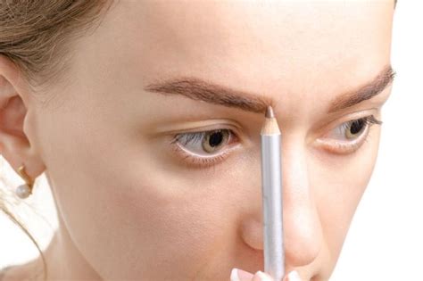 donna che applica matita bianca nella rima interna dell'occhio