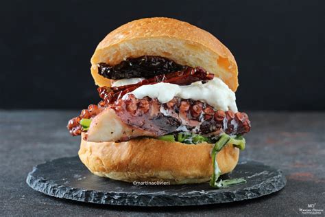 Panino con polpo arrosto su un tavolo di legno con sfondo marino